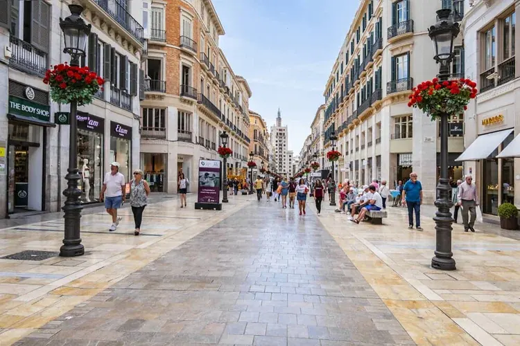 Pedestrian shopping street Calle Larios lined with historic buildings in Málaga