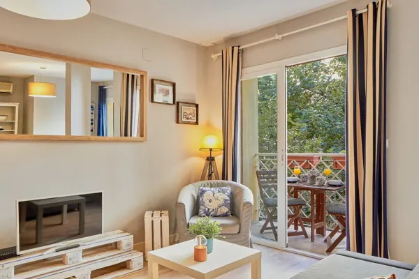 Living room seating corner beside the balcony at H&T Dream Stays apartment in Málaga